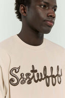 Beige t-shirt with 3D silicone buttercream-style SSSTUFFF logo graphic