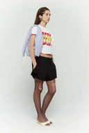 Blue striped croissant-shaped mini bag with shirt texture and adjustable sleeve handles for shoulder or crossbody wear