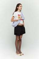 Blue striped croissant-shaped mini bag with shirt texture and adjustable sleeve handles for shoulder or crossbody wear