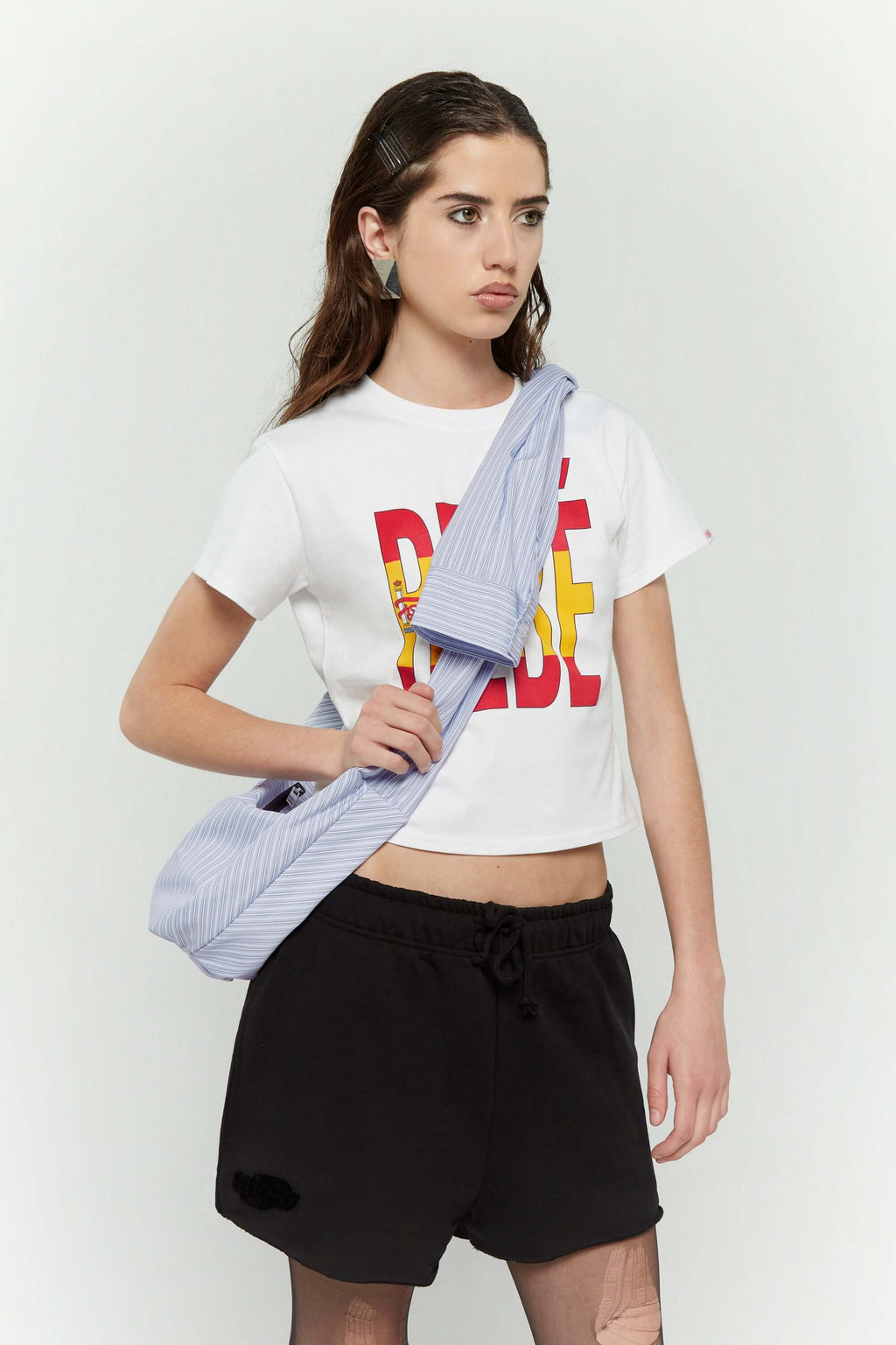 Blue striped croissant-shaped mini bag with shirt texture and adjustable sleeve handles for shoulder or crossbody wear