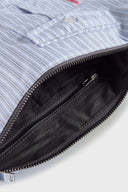 Blue striped croissant-shaped mini bag with shirt texture and adjustable sleeve handles for shoulder or crossbody wear