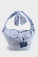 Blue striped croissant-shaped bag with shirt texture and adjustable sleeve handles for shoulder or crossbody wear, includes leather cardholder