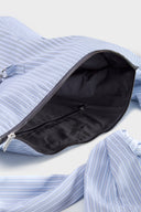 Blue striped croissant-shaped bag with shirt texture and adjustable sleeve handles for shoulder or crossbody wear, includes leather cardholder