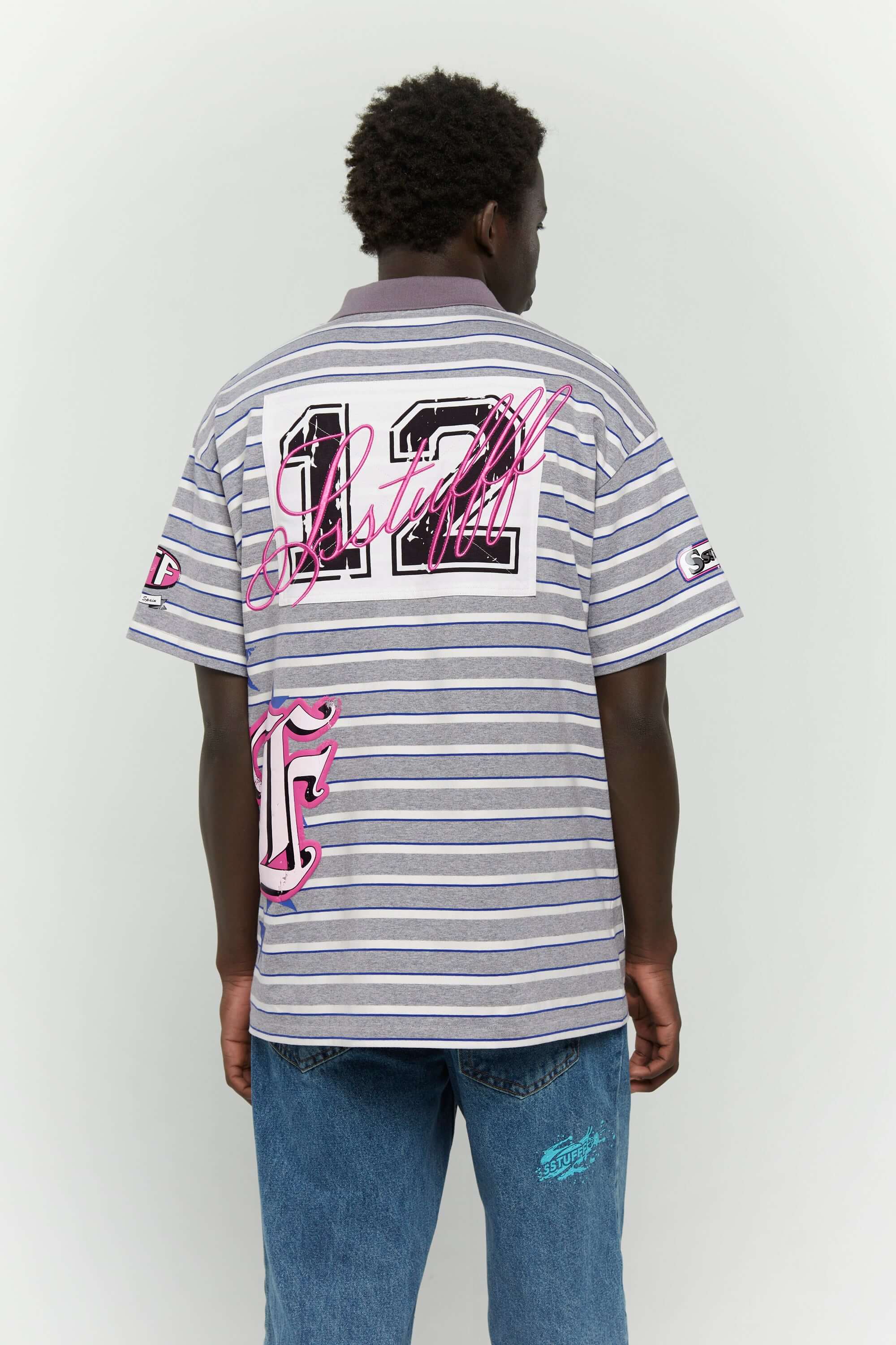 Grey striped polo shirt with embroidery, PVC, and screenprint graphics inspired by retro birthday party style