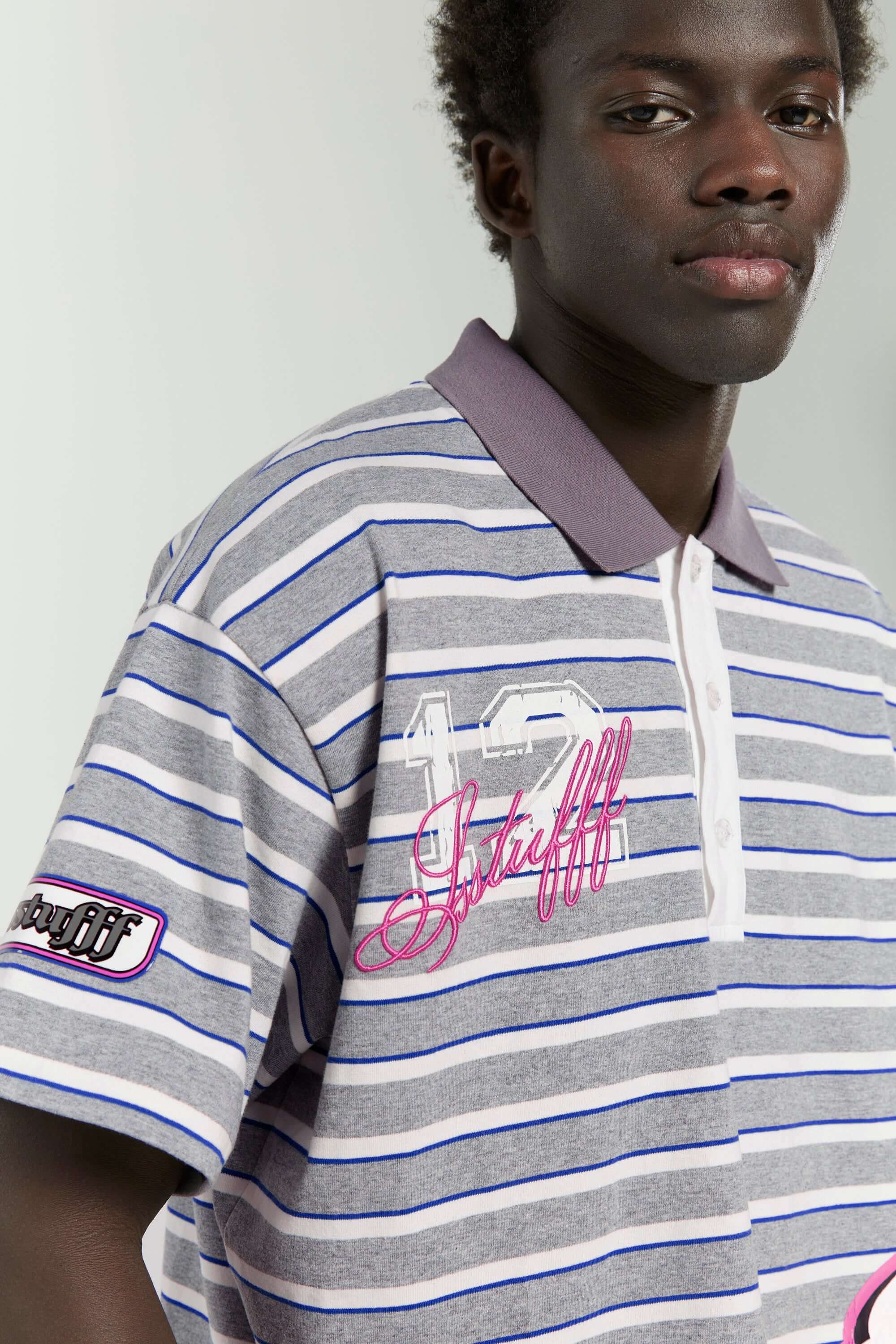 Grey striped polo shirt with embroidery, PVC, and screenprint graphics inspired by retro birthday party style