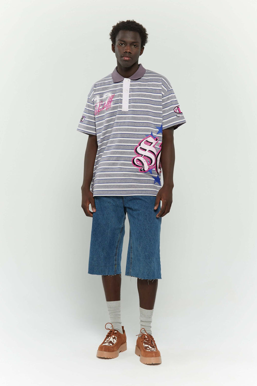 Grey striped polo shirt with embroidery, PVC, and screenprint graphics inspired by retro birthday party style