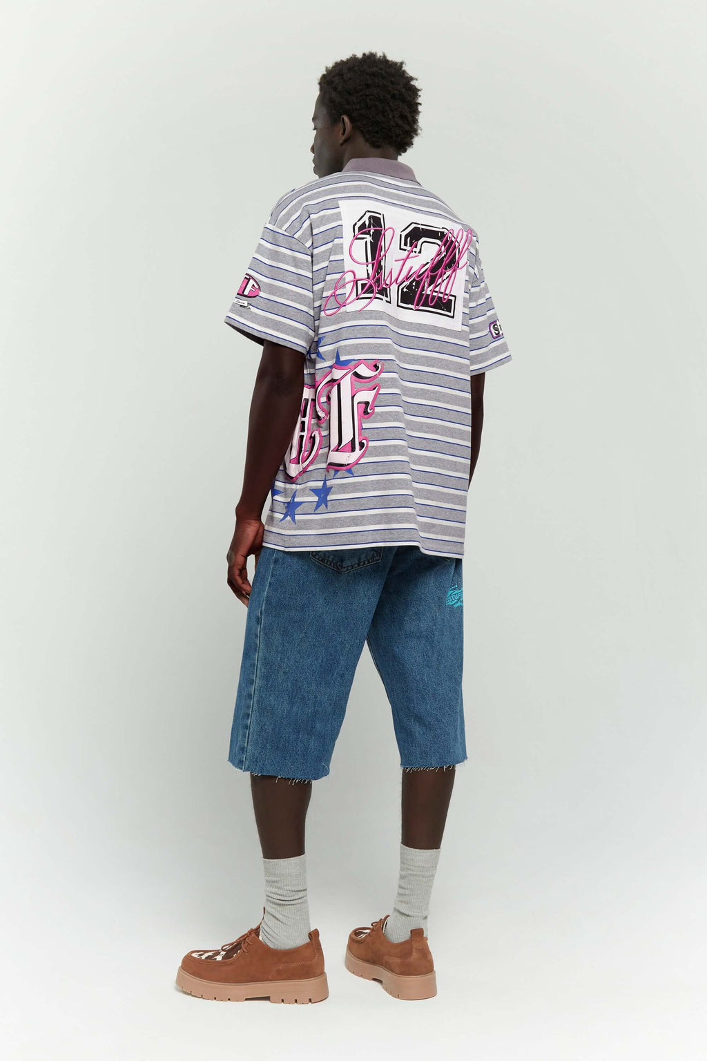 Grey striped polo shirt with embroidery, PVC, and screenprint graphics inspired by retro birthday party style