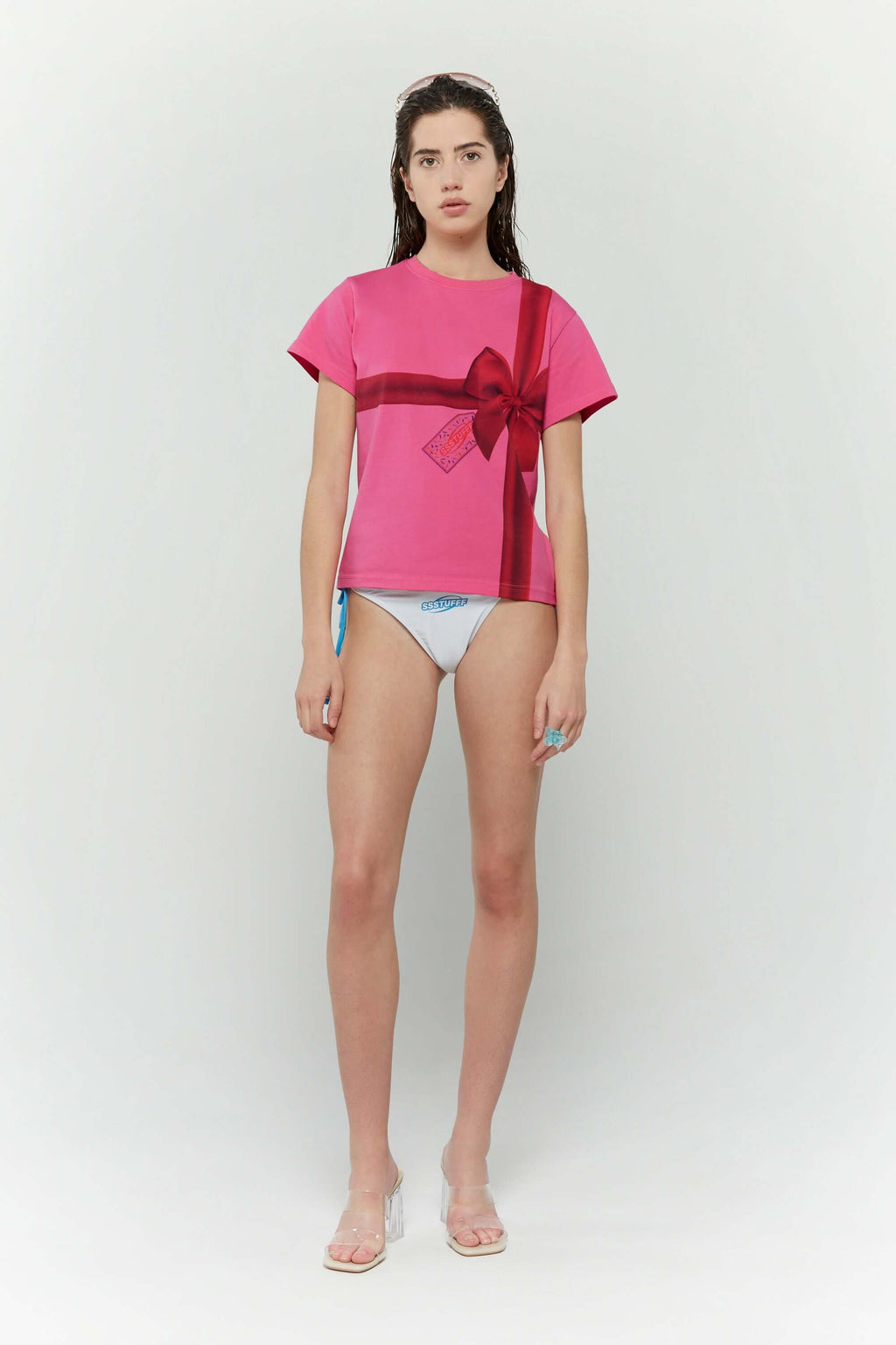Pink t-shirt with a red ribbon graphic mimicking a present