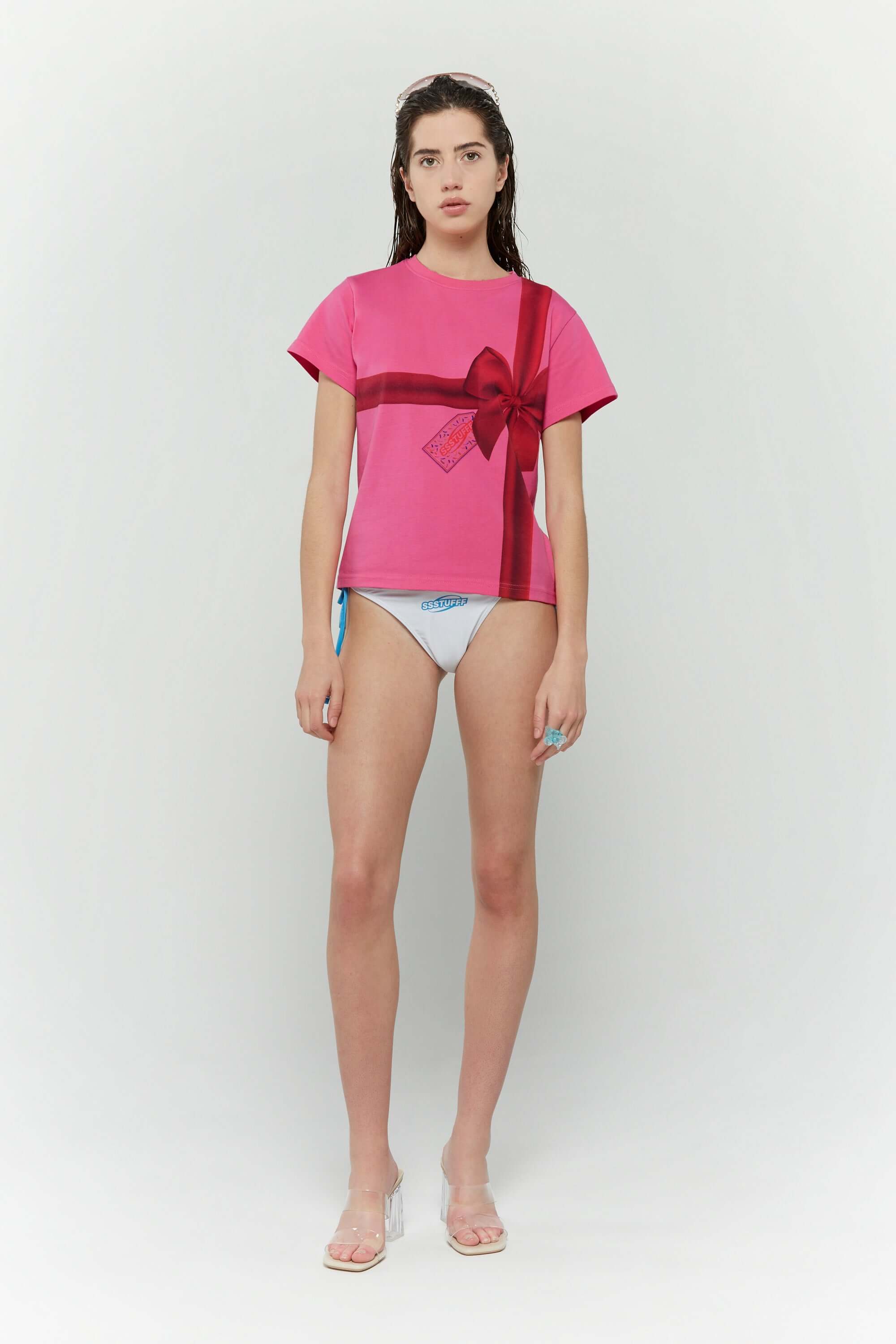 Pink t-shirt with a red ribbon graphic mimicking a present