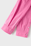 Pink croissant-shaped bag with shirt texture and adjustable sleeve handles for shoulder or crossbody wear