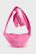 Pink croissant-shaped mini bag with shirt texture and adjustable sleeve handles for shoulder or crossbody wear
