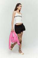 Pink croissant-shaped mini bag with shirt texture and adjustable sleeve handles for shoulder or crossbody wear