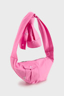 Pink croissant-shaped mini bag with shirt texture and adjustable sleeve handles for shoulder or crossbody wear
