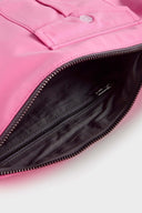Pink croissant-shaped mini bag with shirt texture and adjustable sleeve handles for shoulder or crossbody wear