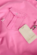 Pink croissant-shaped bag with shirt texture and adjustable sleeve handles for shoulder or crossbody wear, includes leather cardholder