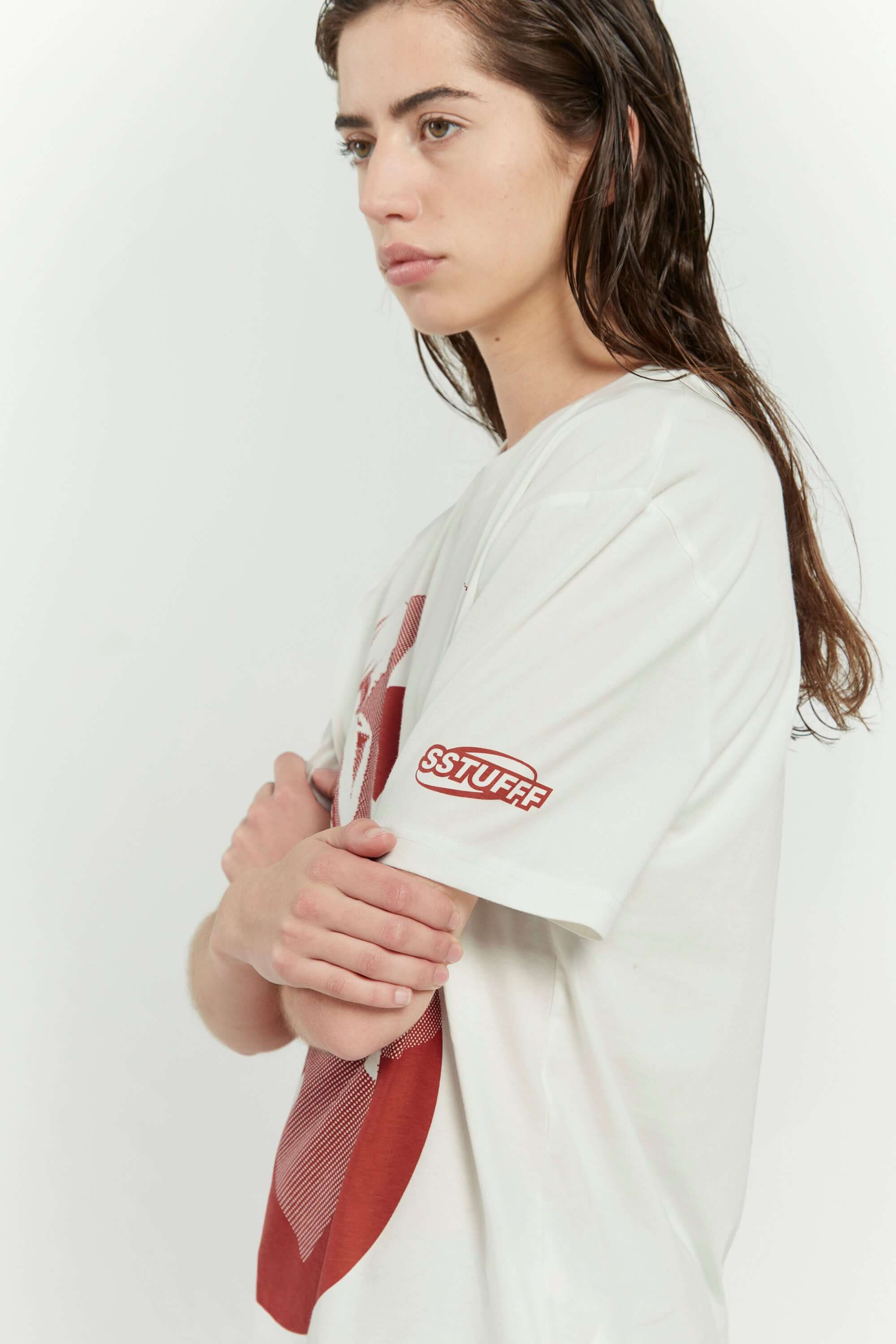 Off white t-shirt with female silhouette looking through large S graphic and SSSTUFFF logo detail on sleeve