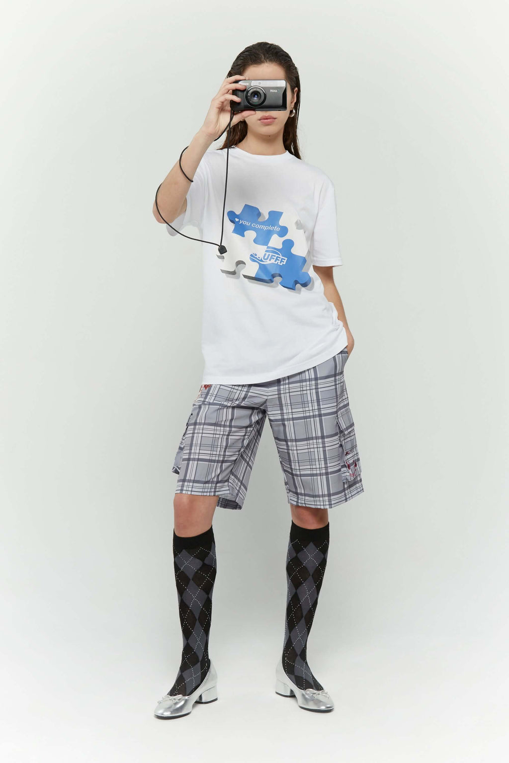 White t-shirt with blue puzzle graphic and hidden UV reactive puzzle pieces print that turns pink in sunlight