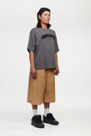 Beige bermuda shorts with a logo embroidered
