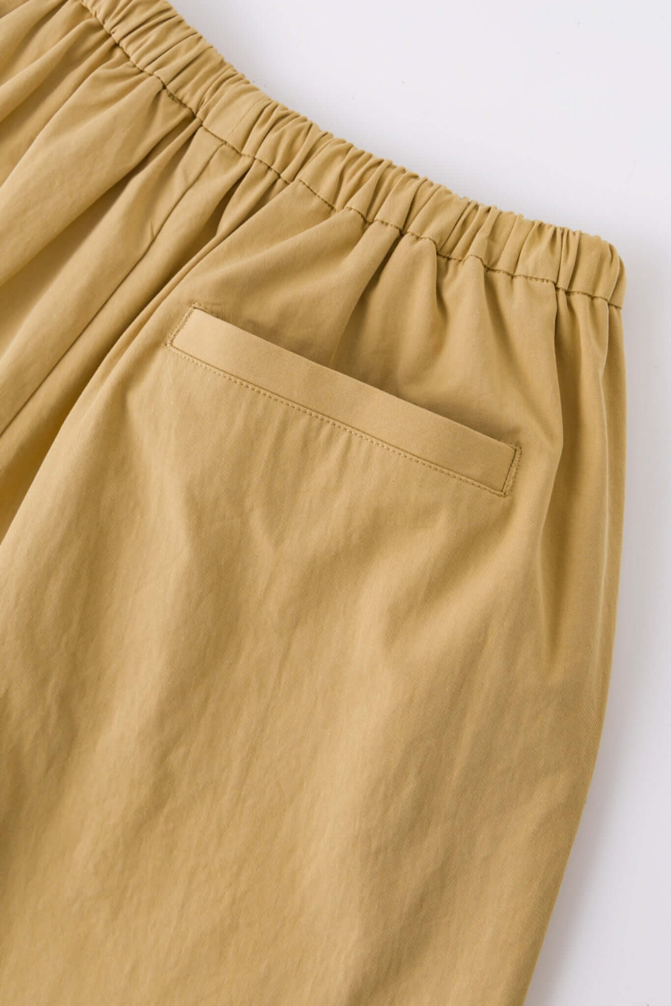 Beige bermuda shorts with a logo embroidered