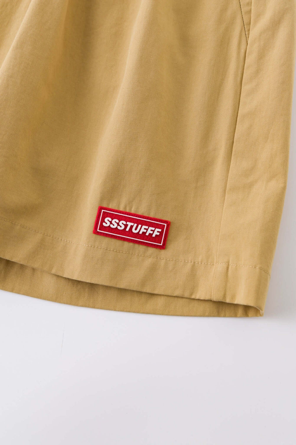 Beige boxer shorts with a red embroidery logo 
