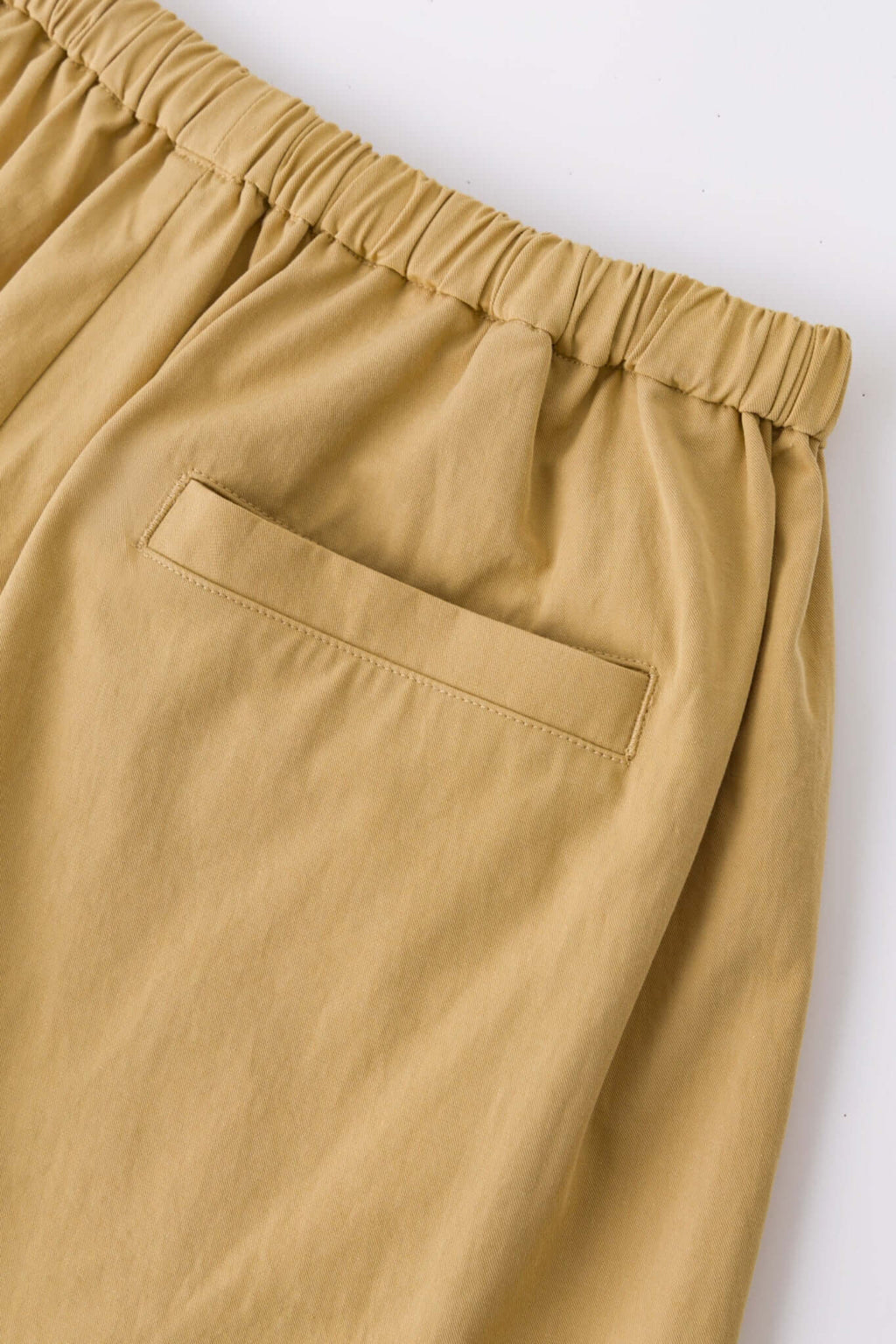Beige boxer shorts with a red embroidery logo 
