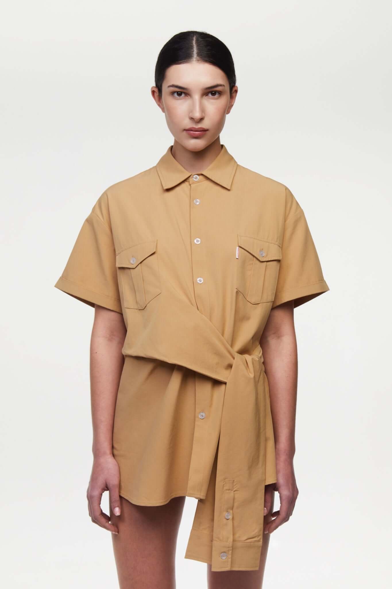 Beige shirt with 4 sleeves making a tie waist 
