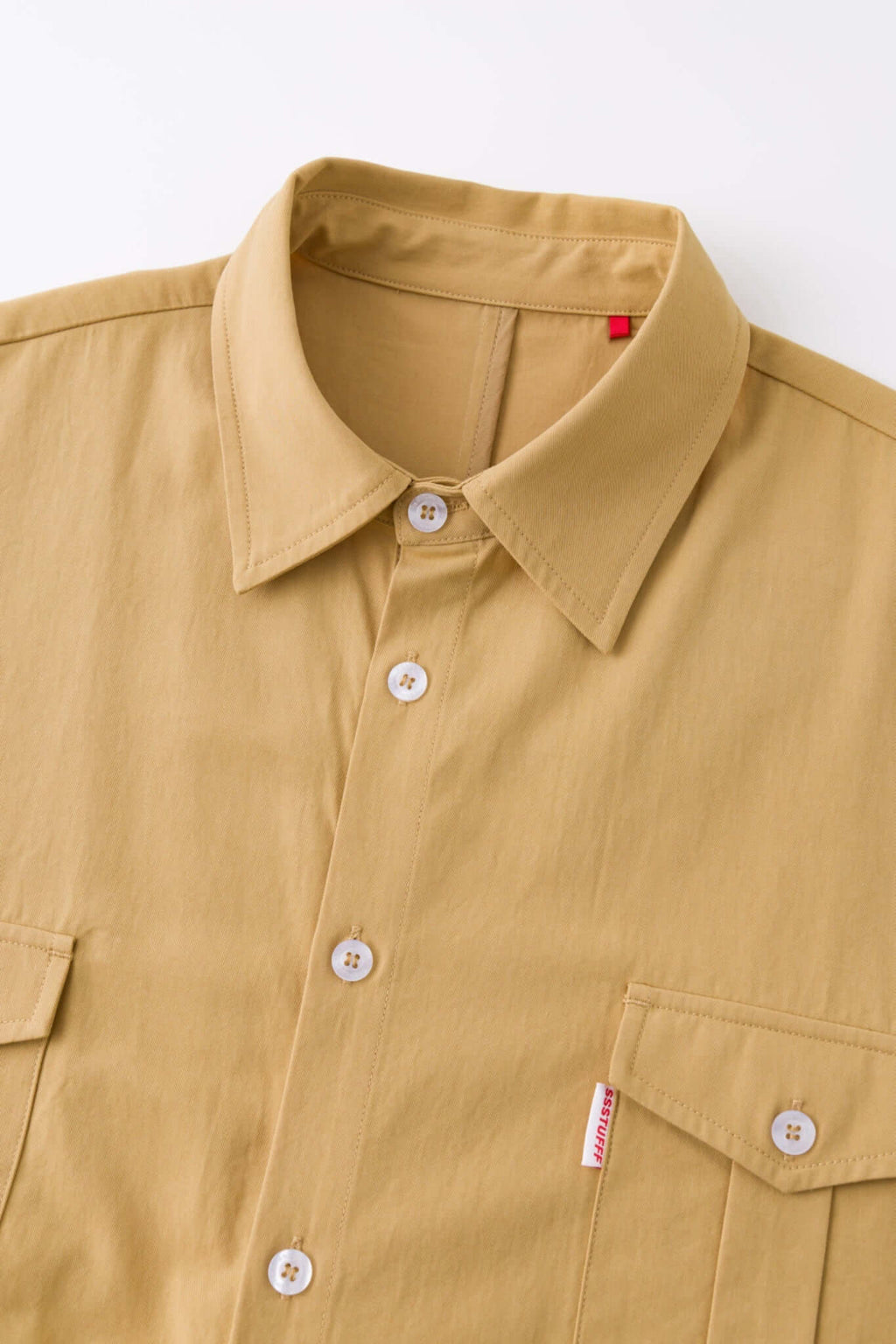 Beige shirt with 4 sleeves making a tie waist 
