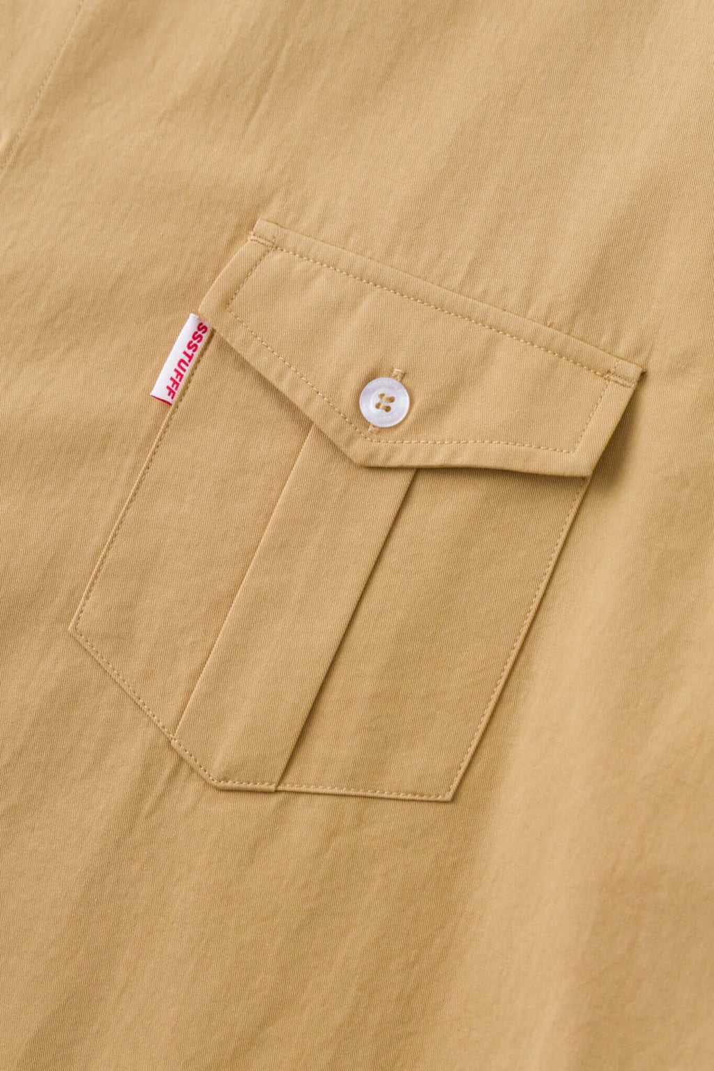 Beige shirt with 4 sleeves making a tie waist 
