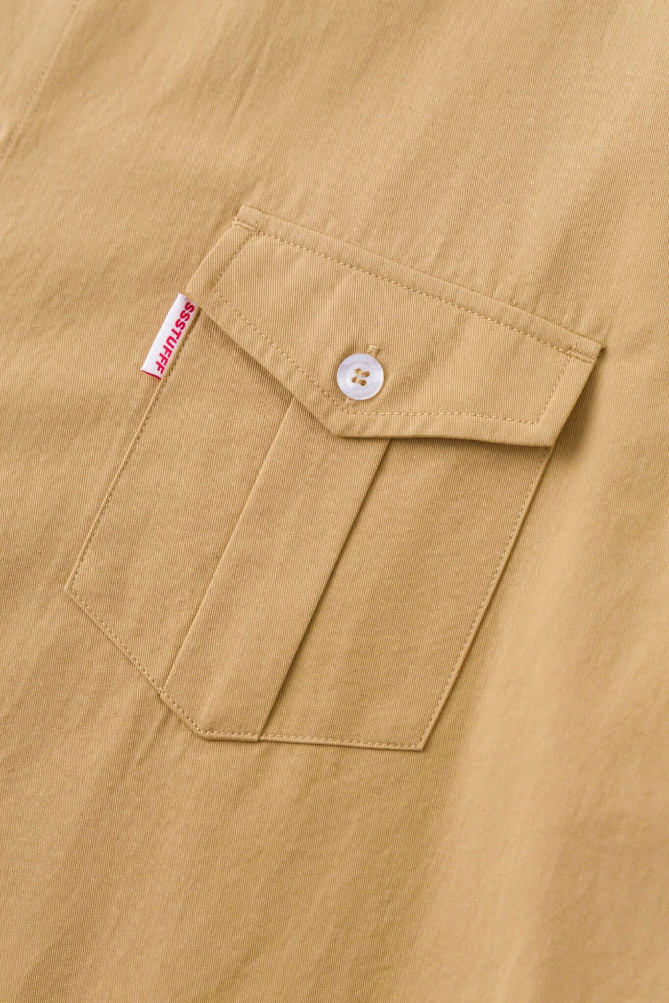 Beige shirt with 4 sleeves making a tie waist 
