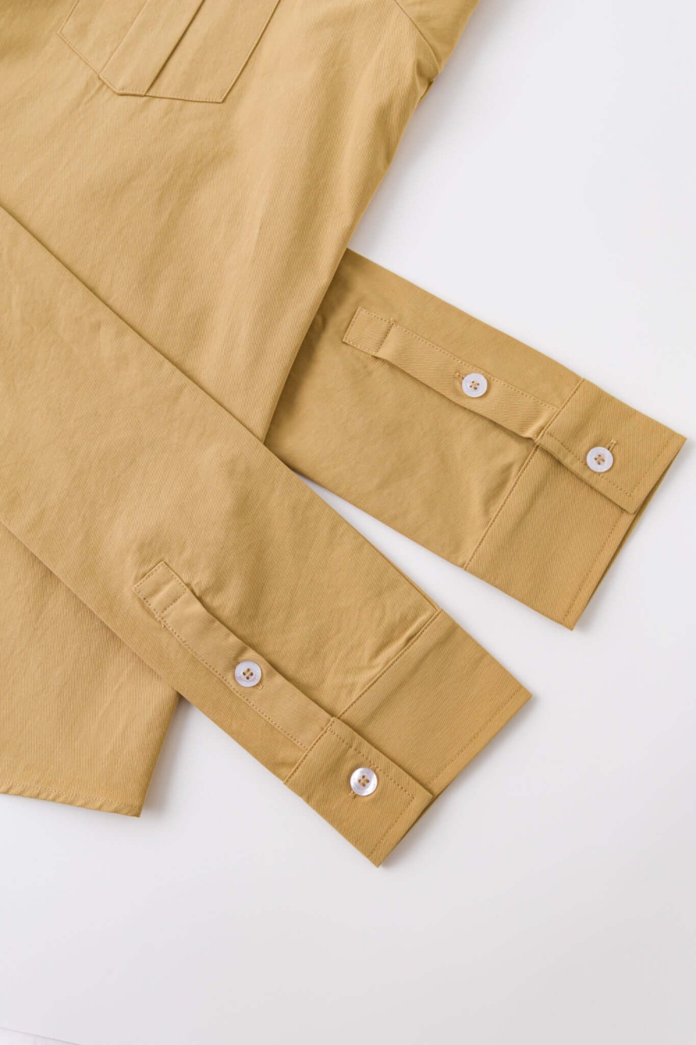 Beige shirt with 4 sleeves making a tie waist 
