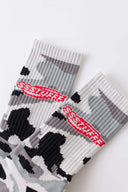 Camouflage-patterned black and grey sock with a brand logo embroidery 
