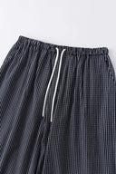 Black striped bermuda shorts with a logo embroidered
