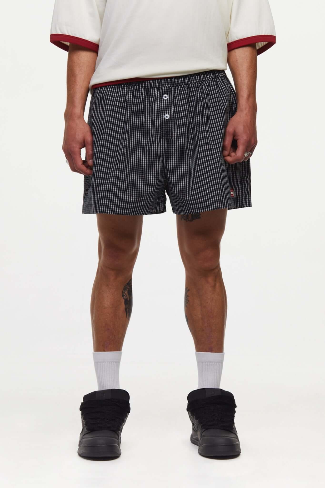 Black striped boxer shorts with a red embroidery logo 
