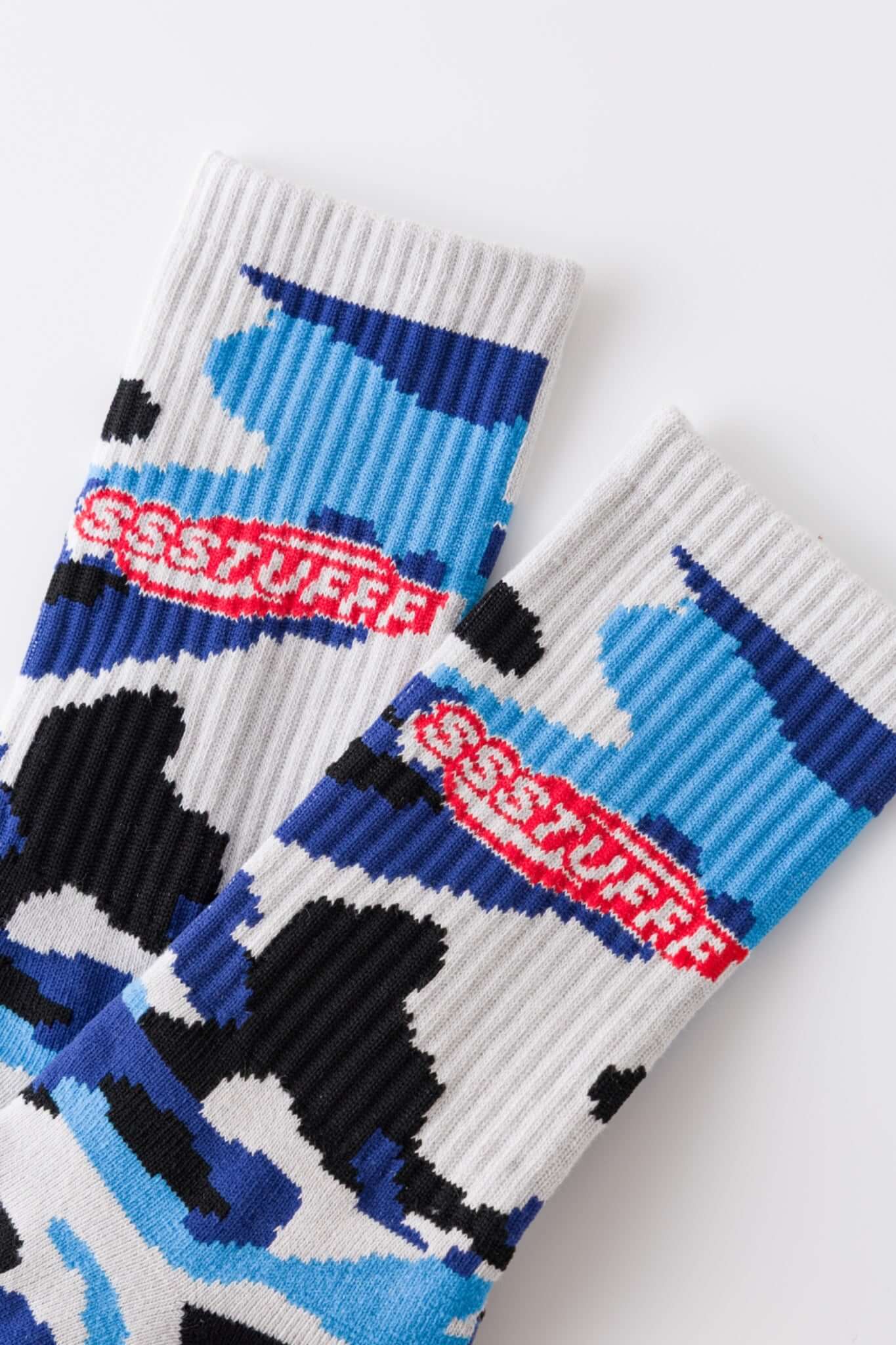 Camouflage-patterned blue sock with a brand logo embroidery 
