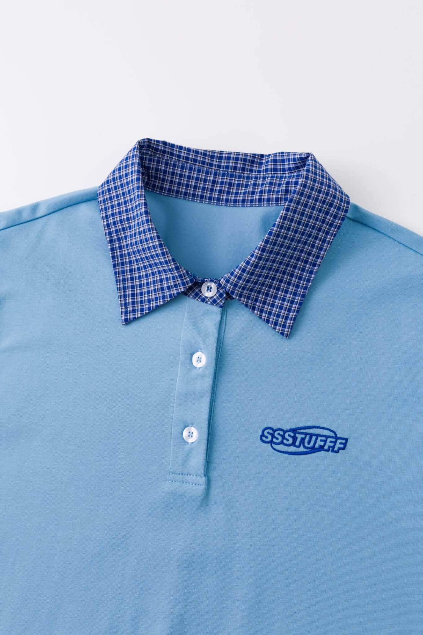 Blue polo shirt with checkered collar and sleeves
