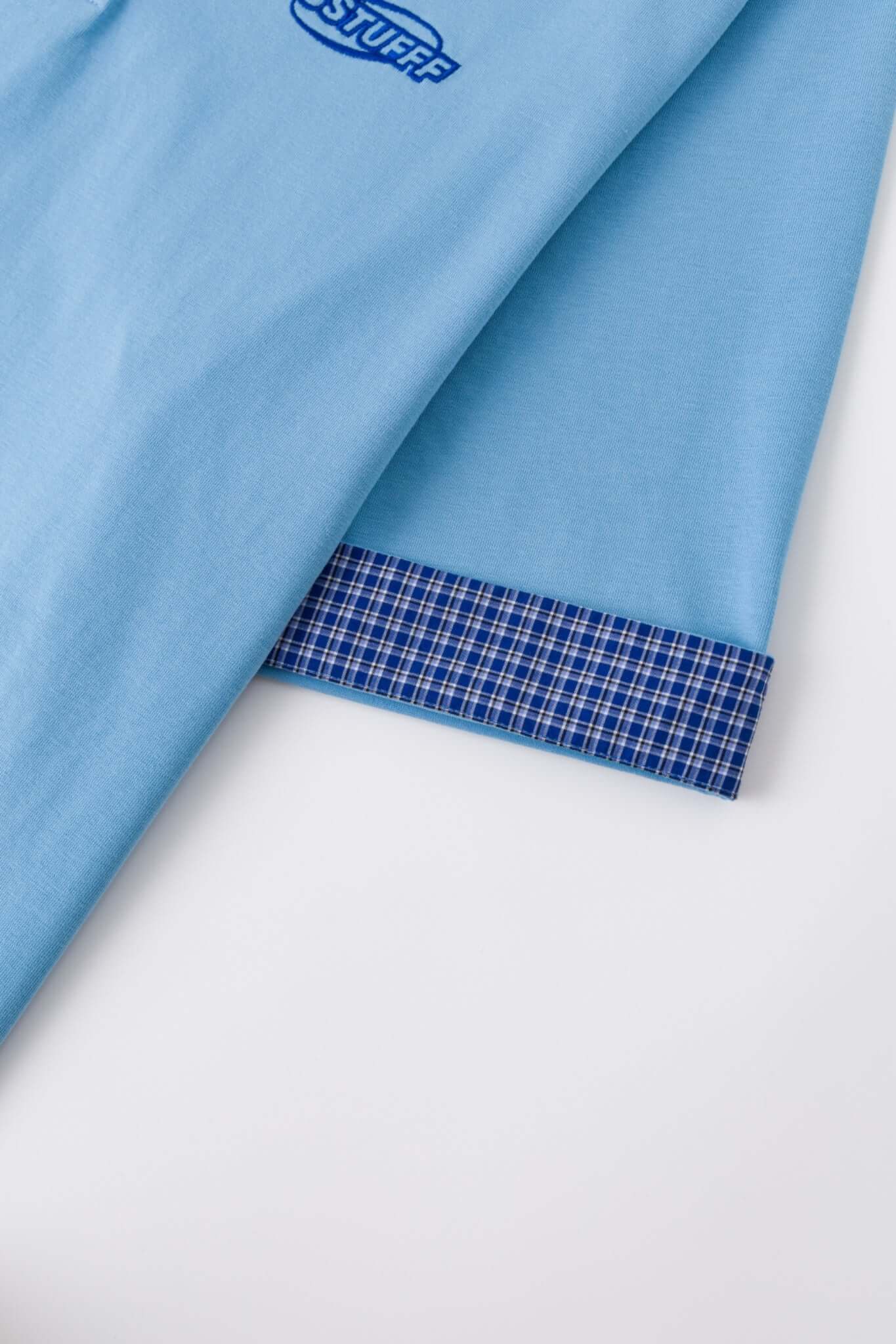 Blue polo shirt with checkered collar and sleeves
