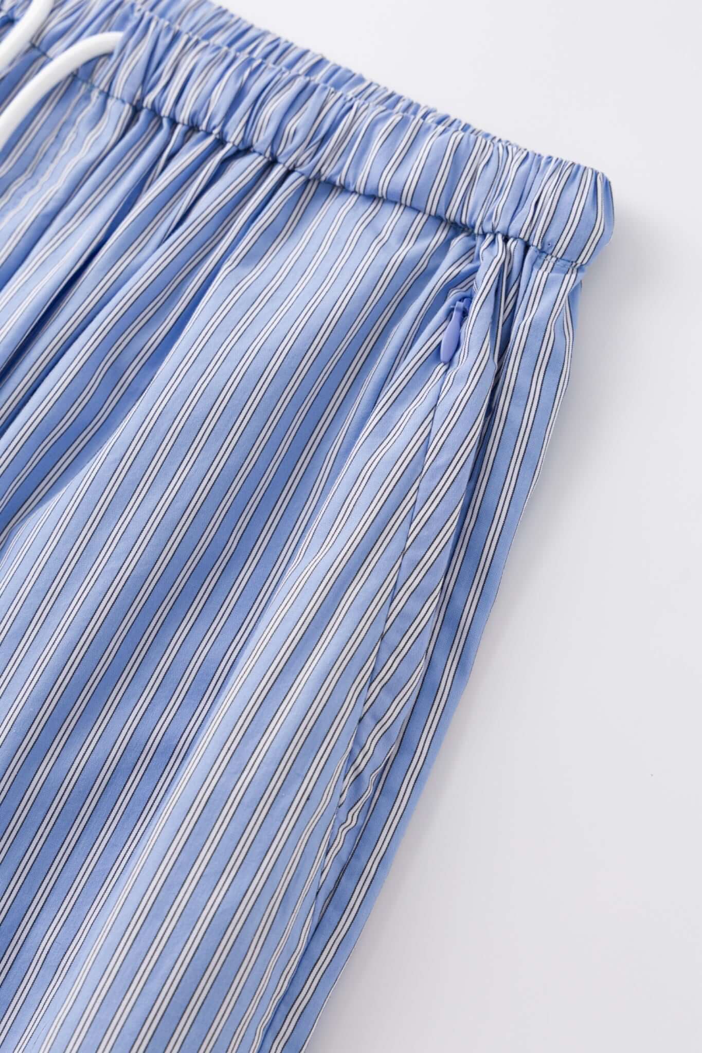 Blue striped bermuda shorts with a logo embroidered
