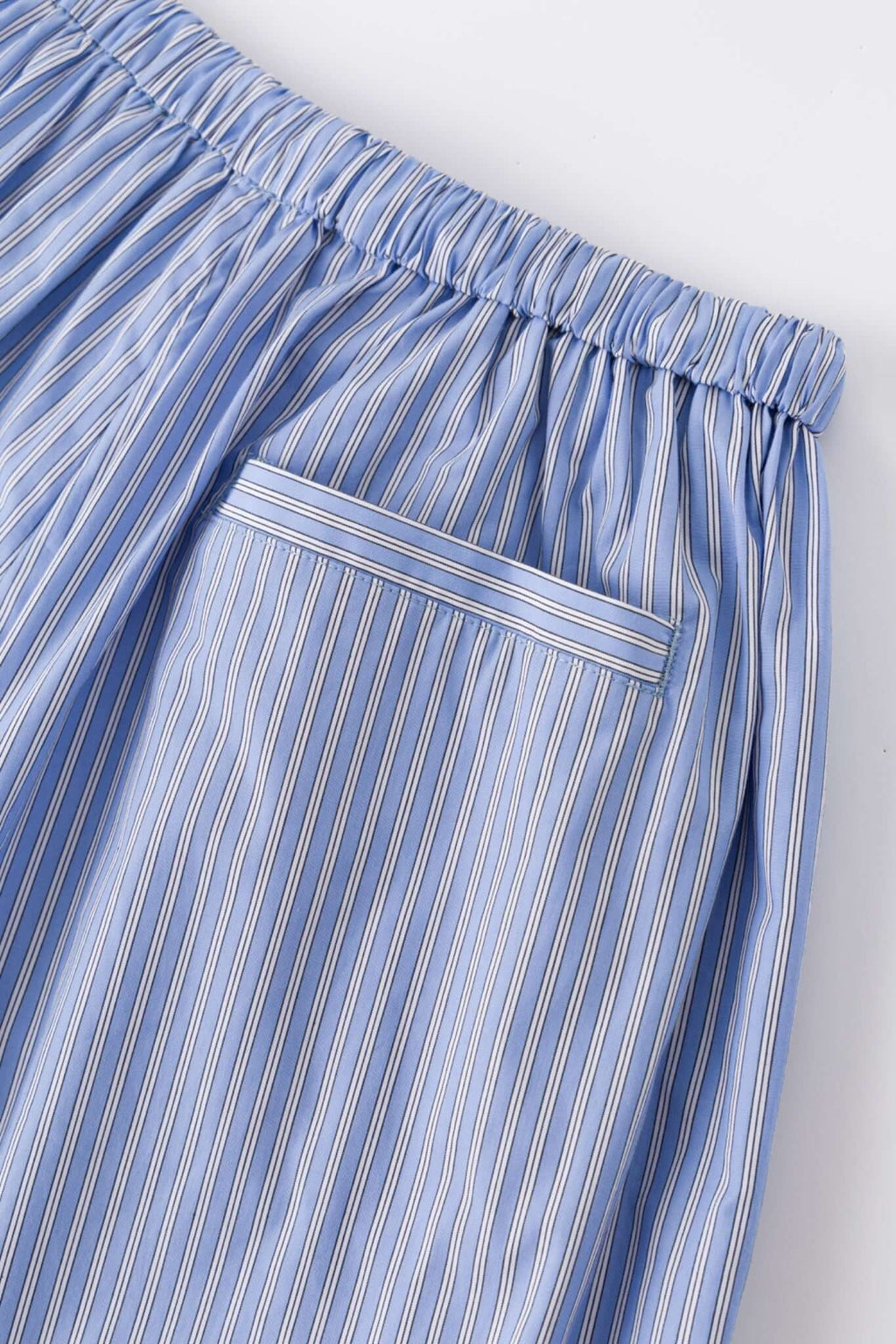 Blue striped bermuda shorts with a logo embroidered
