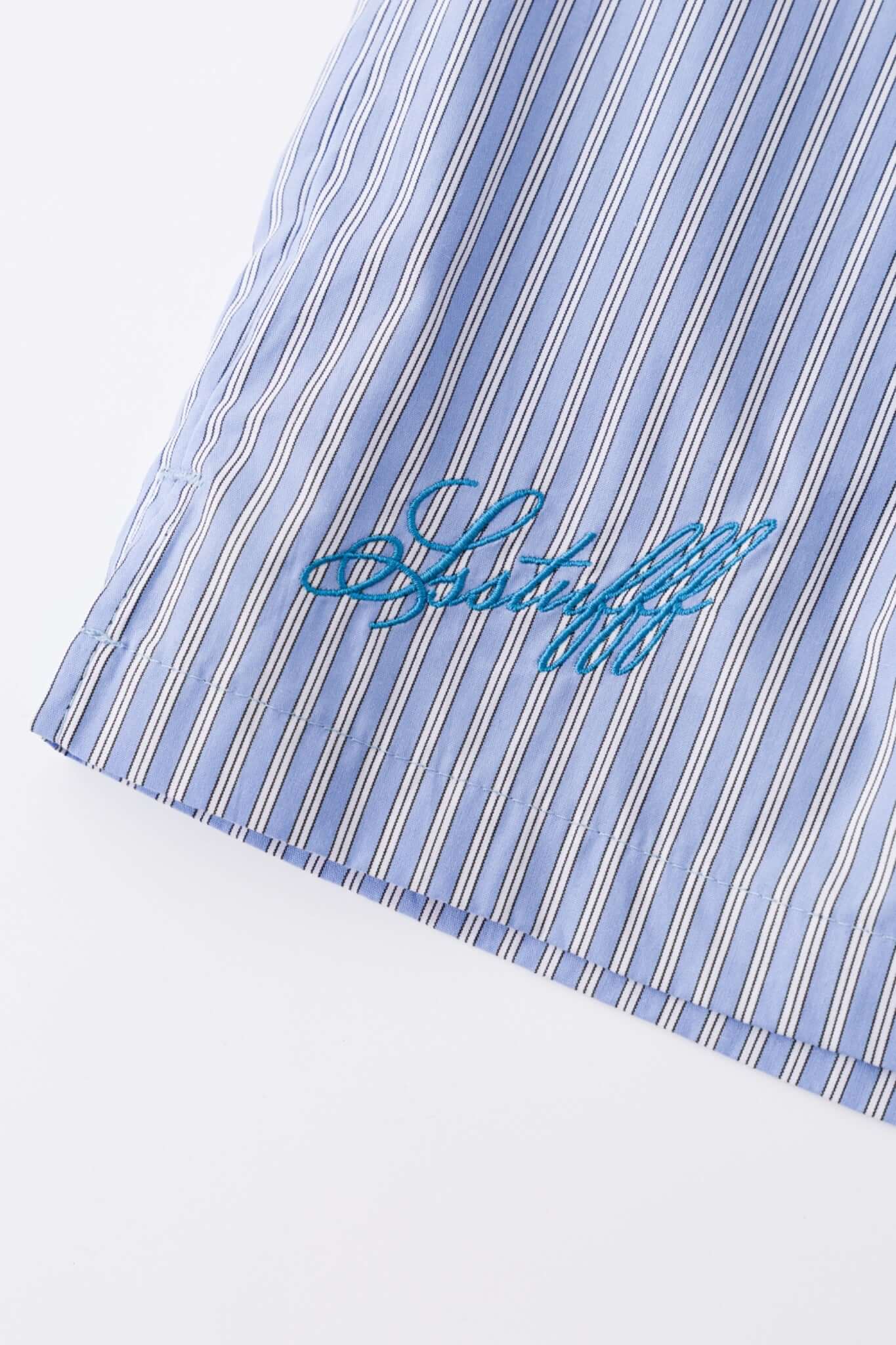 Blue striped bermuda shorts with a logo embroidered
