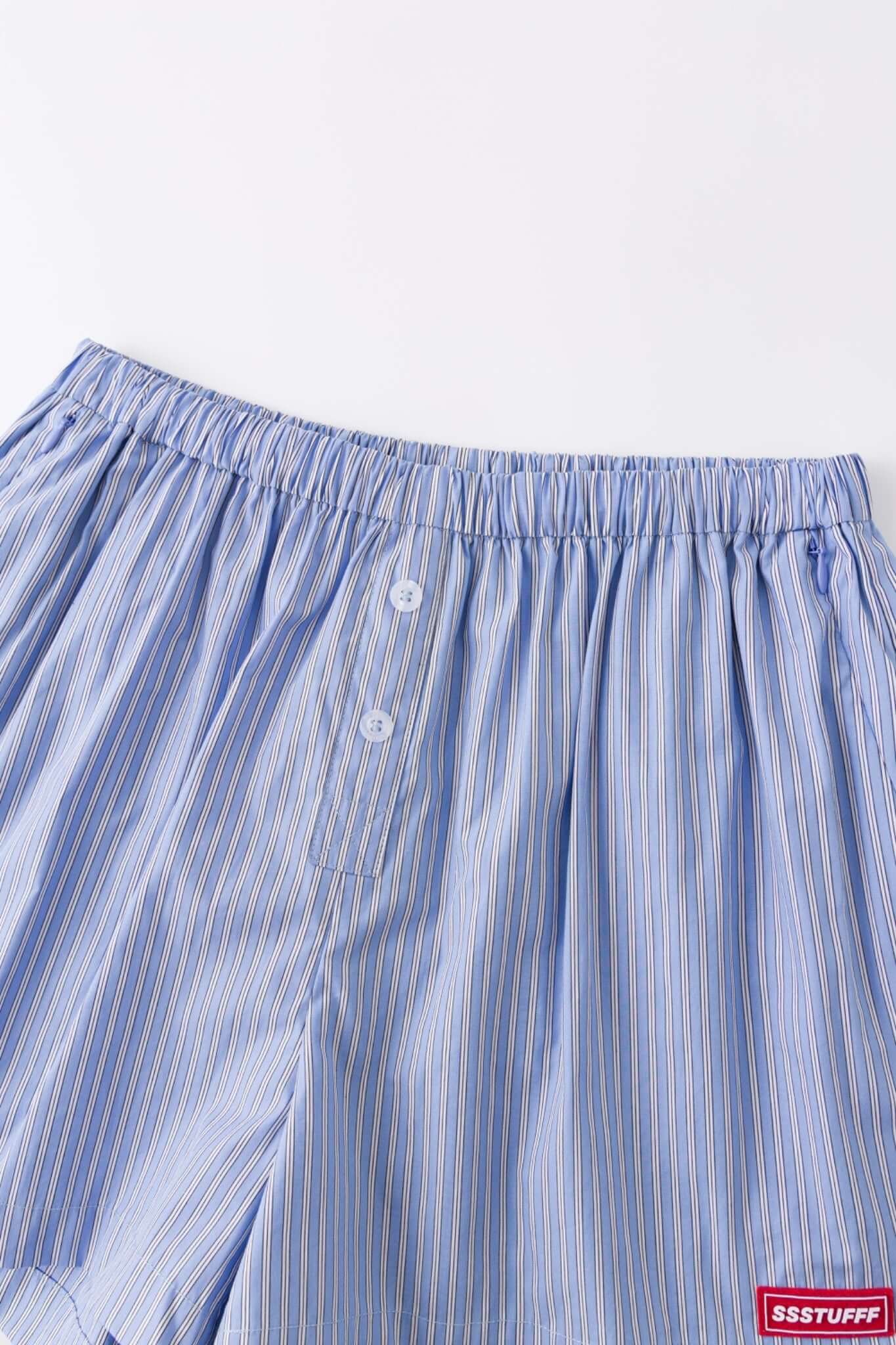 Blue striped boxer shorts with a red embroidery logo 
