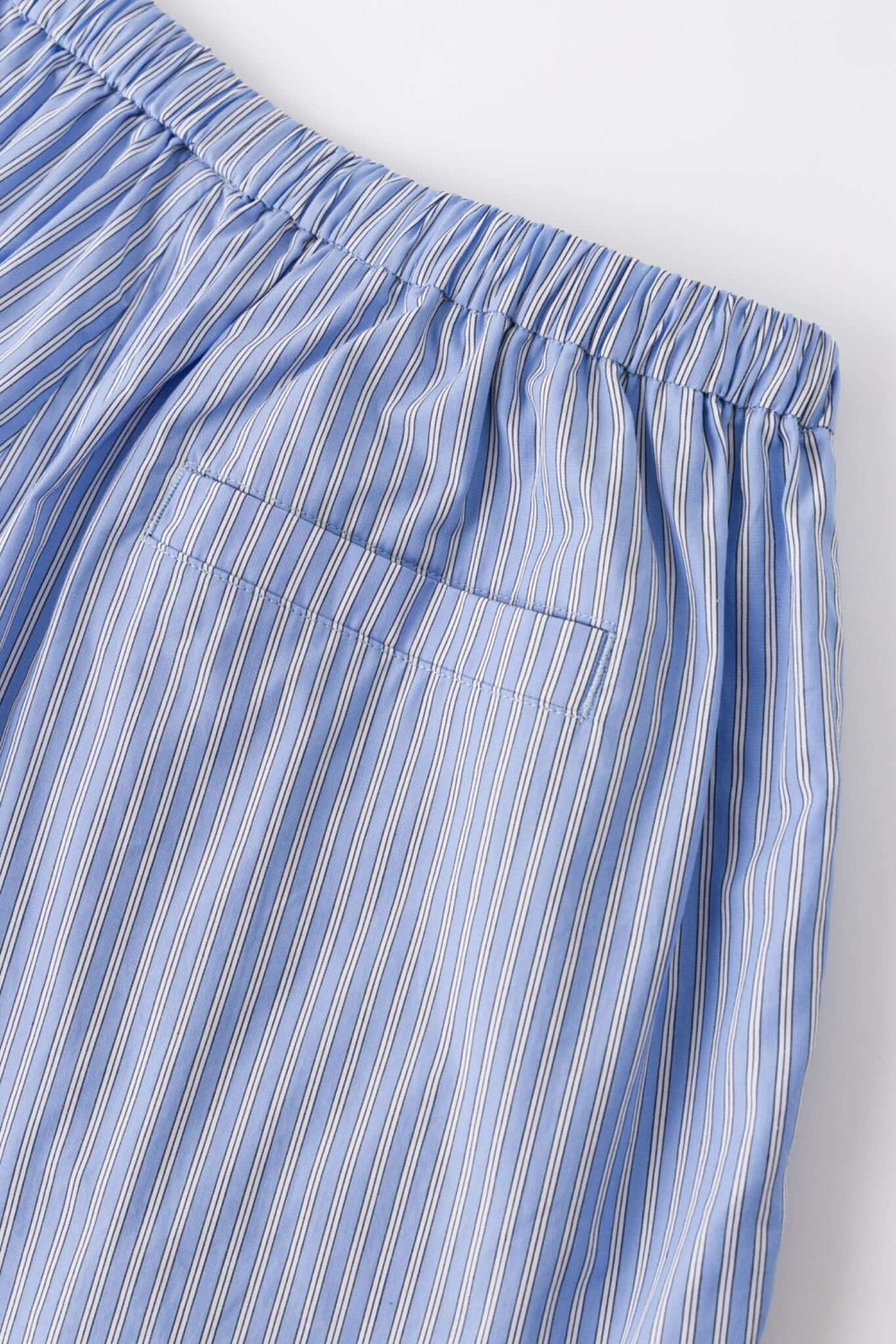 Blue striped boxer shorts with a red embroidery logo 
