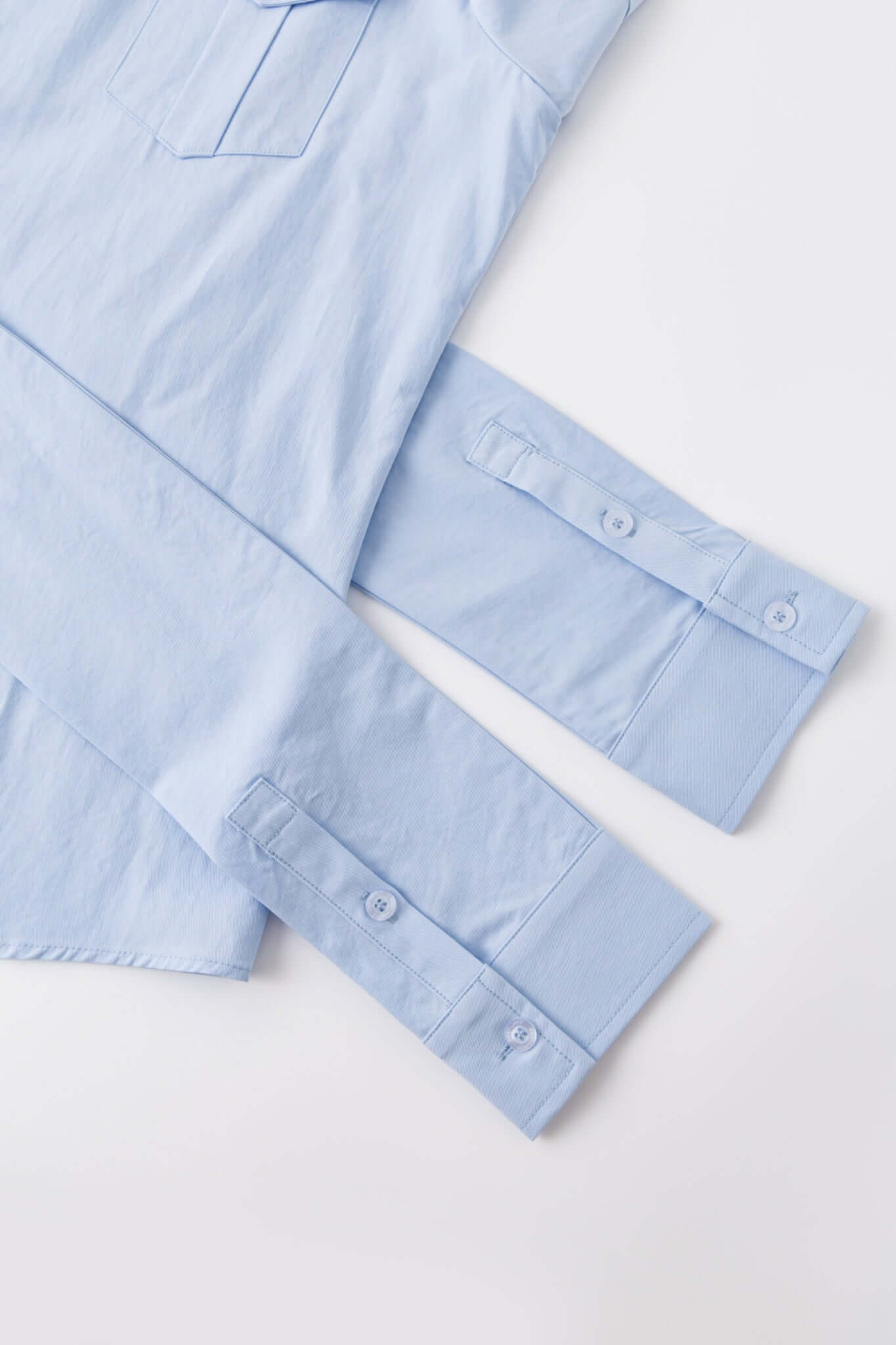 Blue shirt with 4 sleeves making a tie waist 
