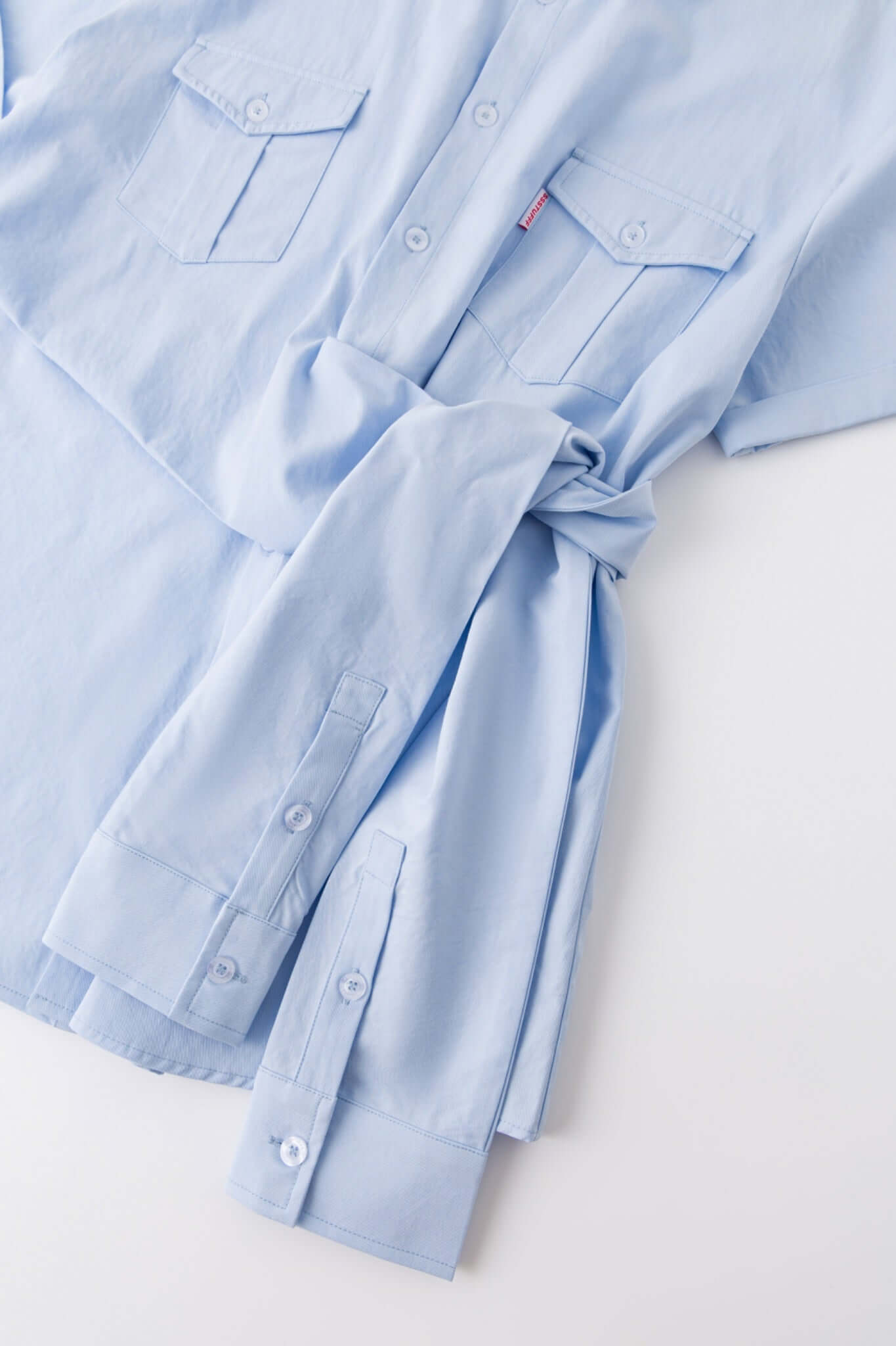 Blue shirt with 4 sleeves making a tie waist 

