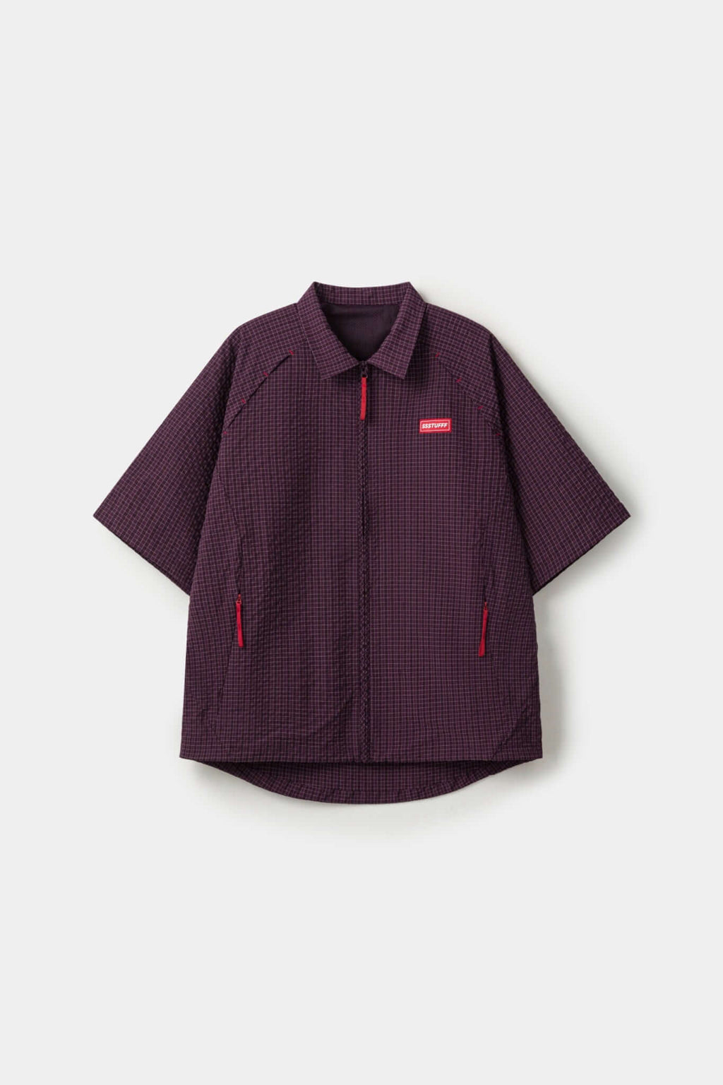 Burgundy checkered shirt with a red logo and red details in the zipper