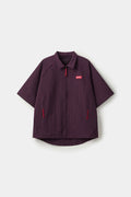 Burgundy checkered shirt with a red logo and red details in the zipper