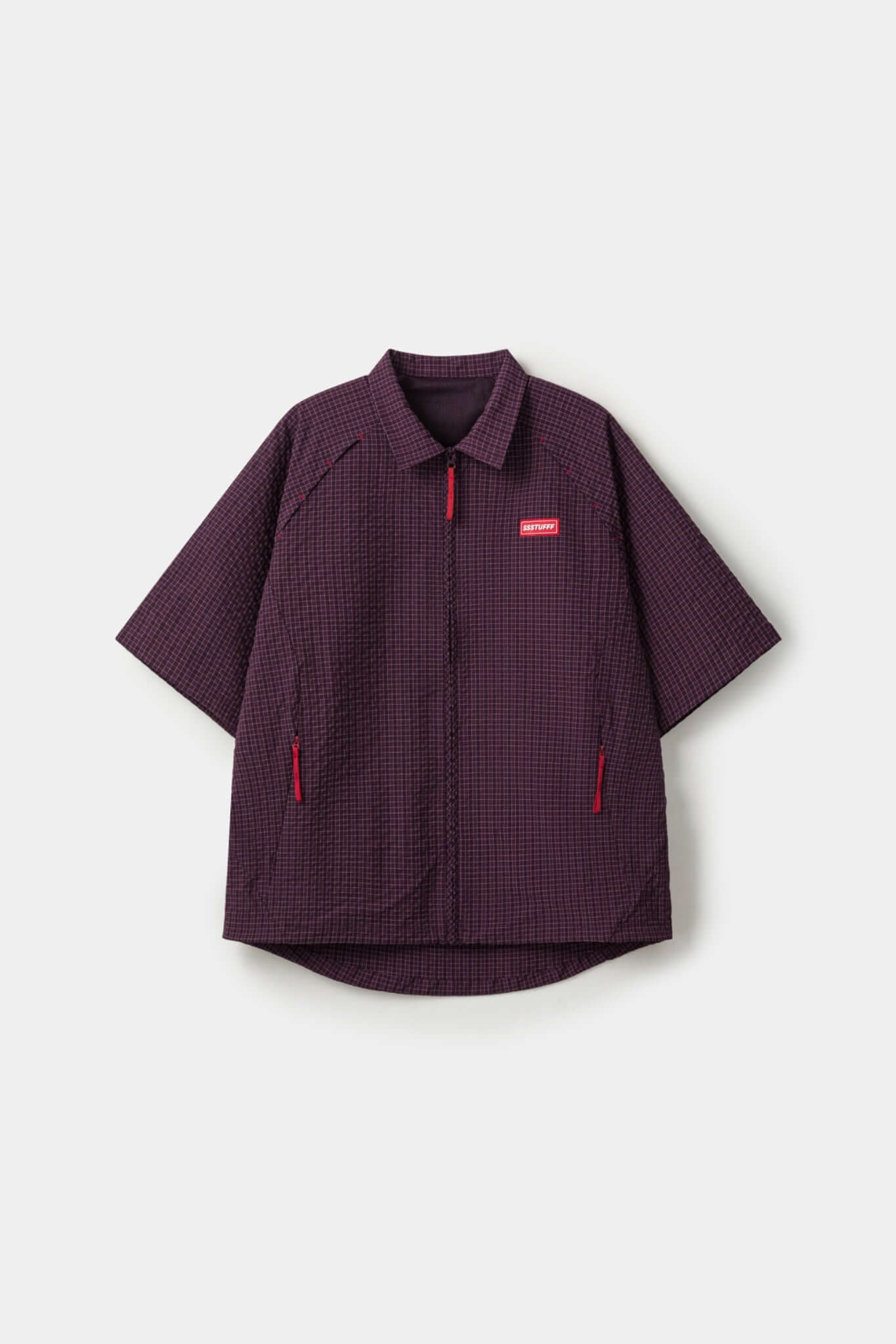 Burgundy checkered shirt with a red logo and red details in the zipper