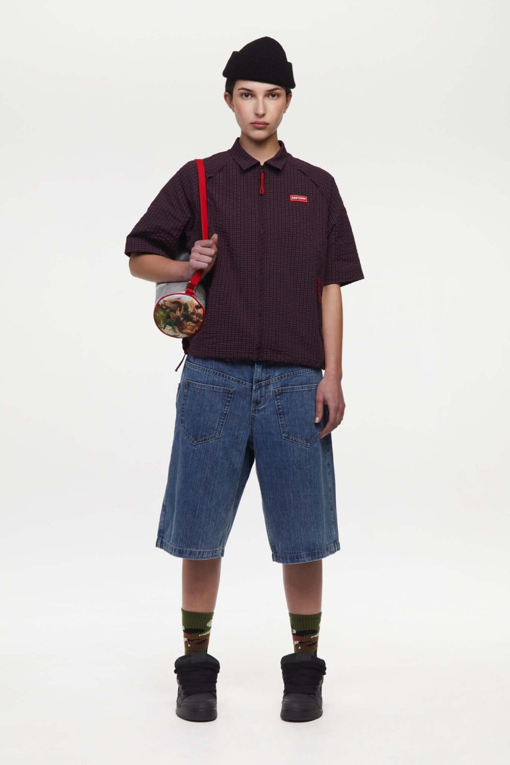 Burgundy checkered shirt with a red logo and red details in the zipper
