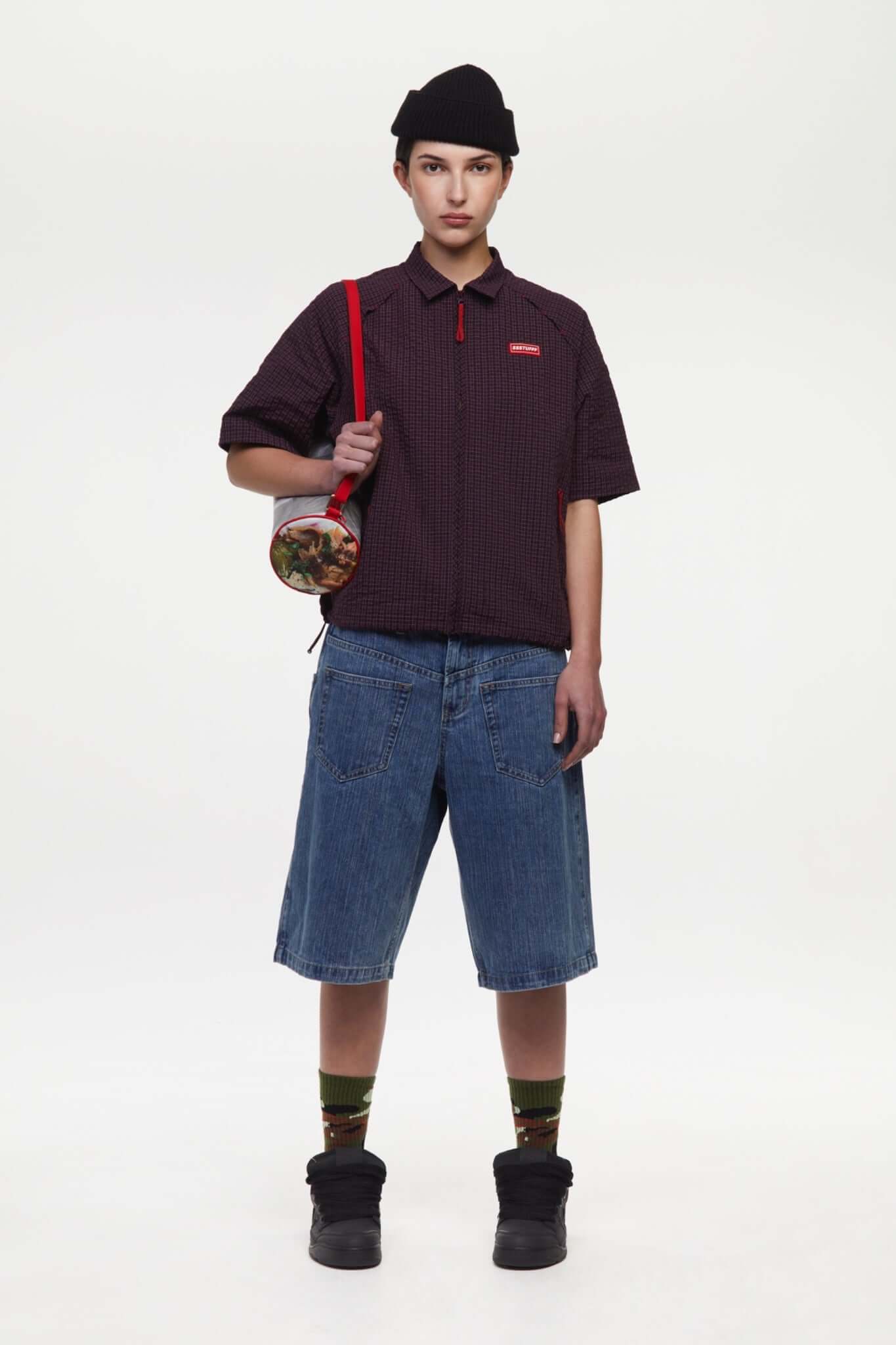 Burgundy checkered shirt with a red logo and red details in the zipper
