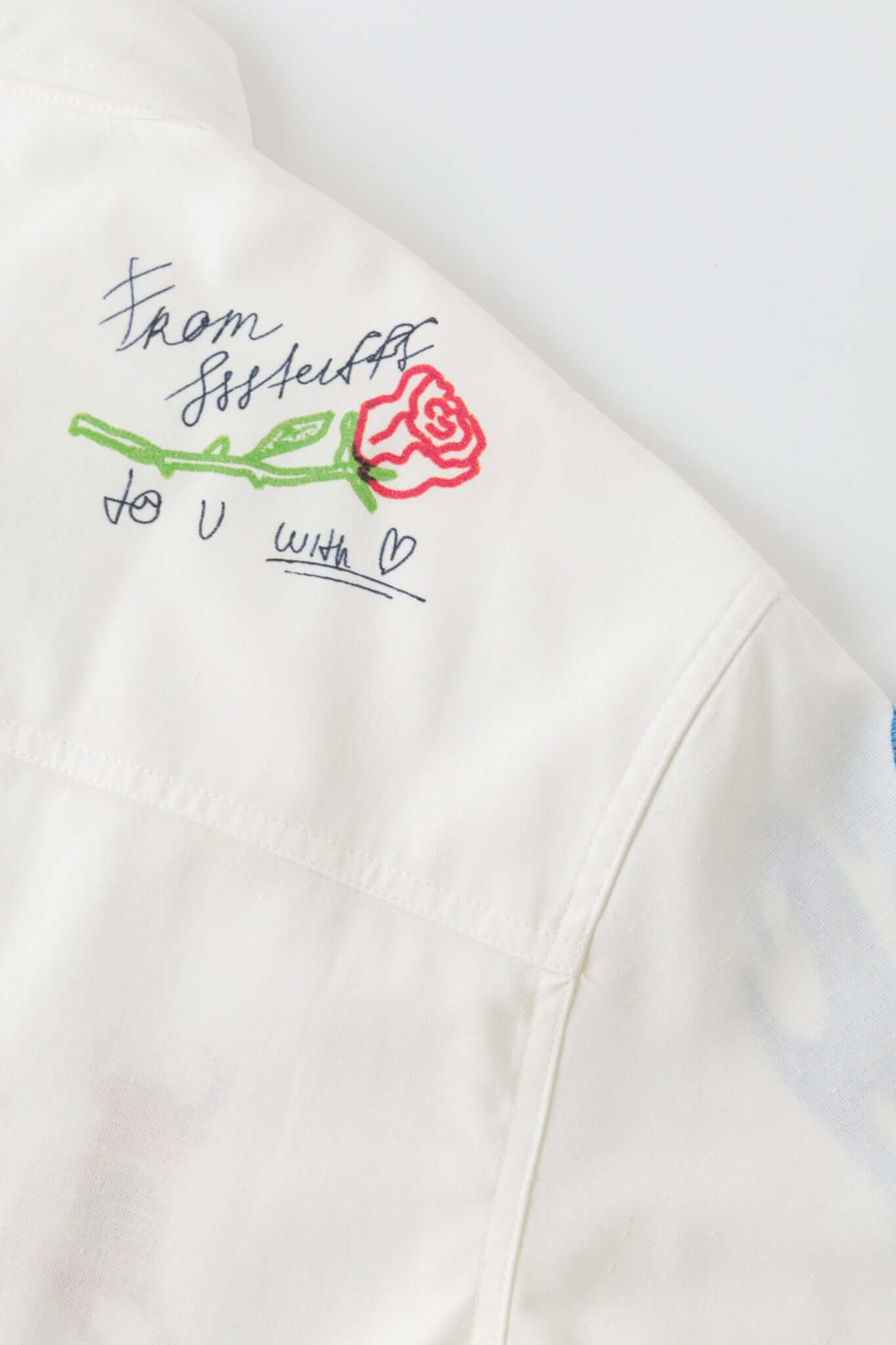 White shirt with colorful graphics simulating a plaster 
