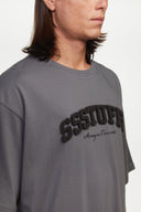 Gray t-shirt with sponge texture text with the brand name
